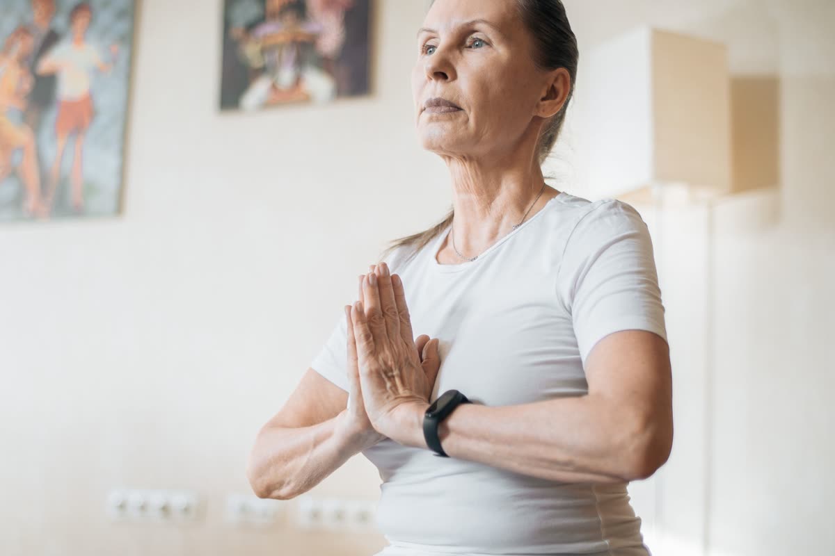 A woman sitting upright at home, composed and ready to begin a session.